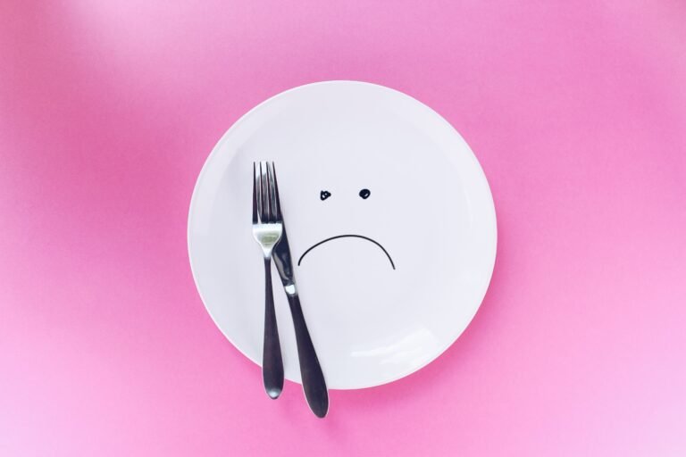 empty plate with a frowning face painted on it