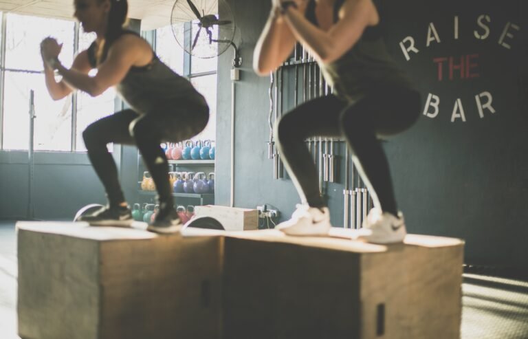 two women doing box jump exercise