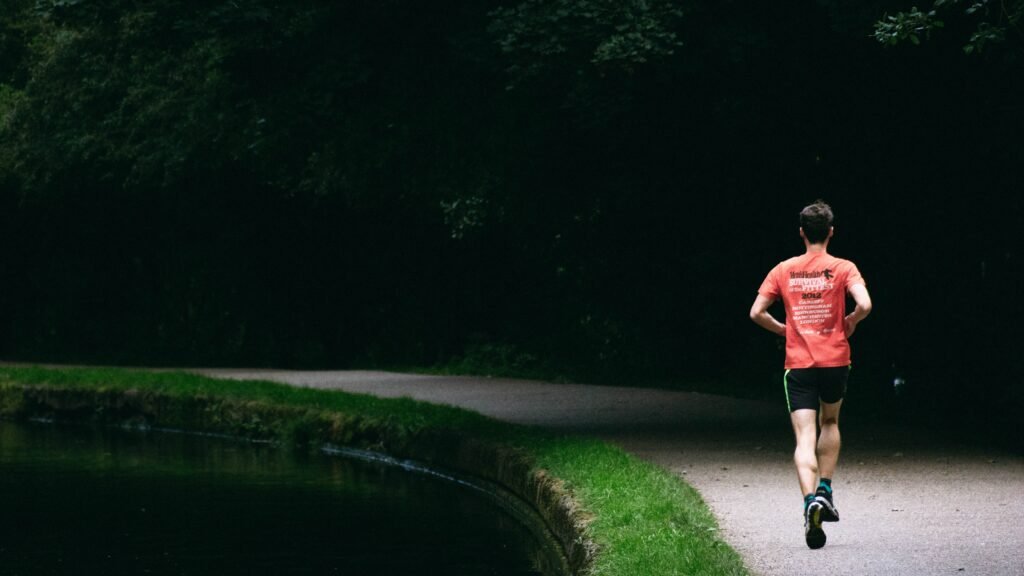 man running in park near lake